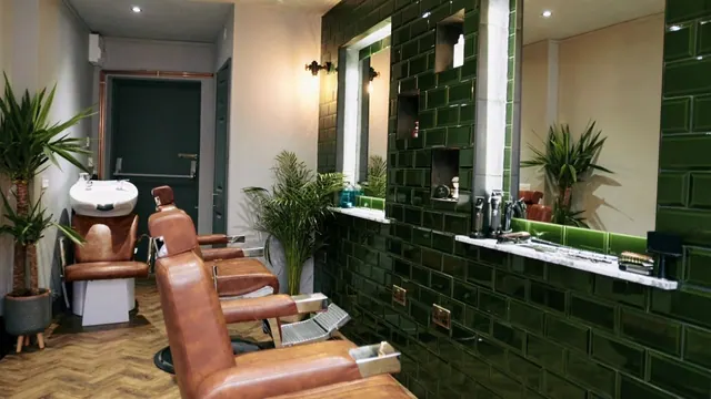 Inside Bank Barbershop: the green tiles and leather chairs