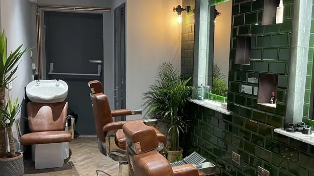 A chair by the plants at Bank Barbershop