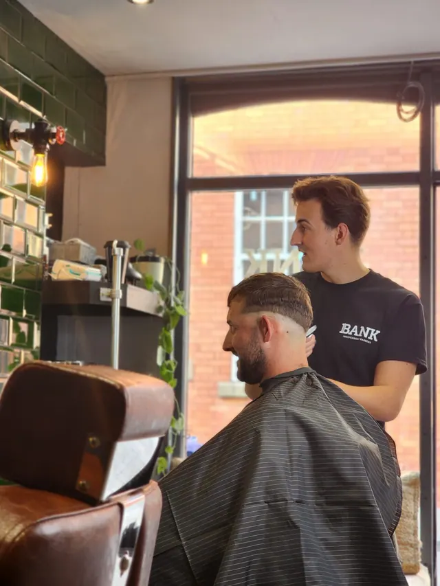 A cut in progress at Bank Barbershop